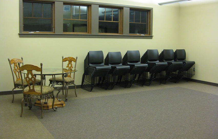 Large open room with stacks of chairs