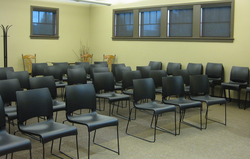 Rows of black chairs in conference room