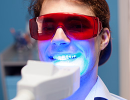 Man receiving in-office teeth whitening treatment