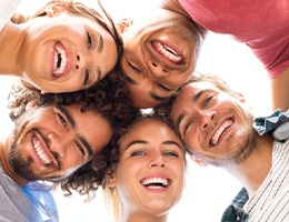 A group of young men and women smiling and feeling confident about their appearances