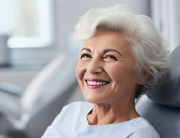 Older woman enjoying her implant dentures  