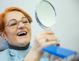 Older woman pleased with dentures in Castle Rock
