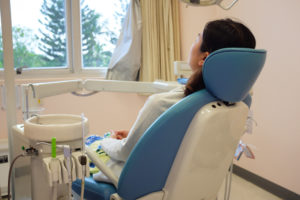 woman in the dental chair facing window