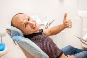 man giving the thumbs up in the dental chair