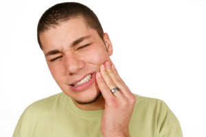 man with a toothache needs to call the dentist longview trusts